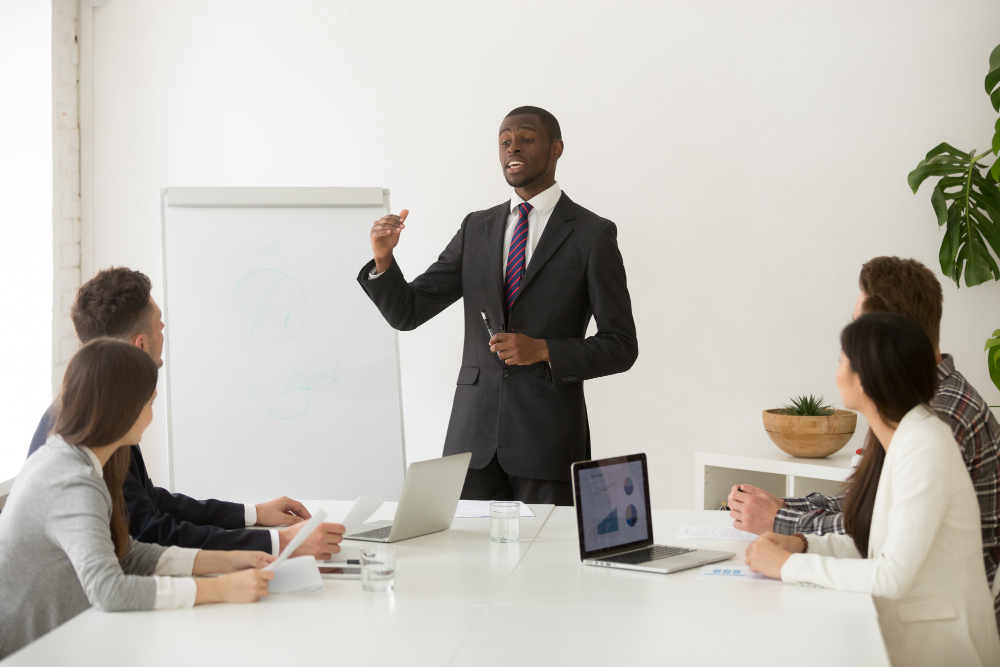 Image of a man speaking to people in a room