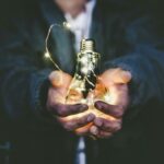 Image showing a man holding a light bulb