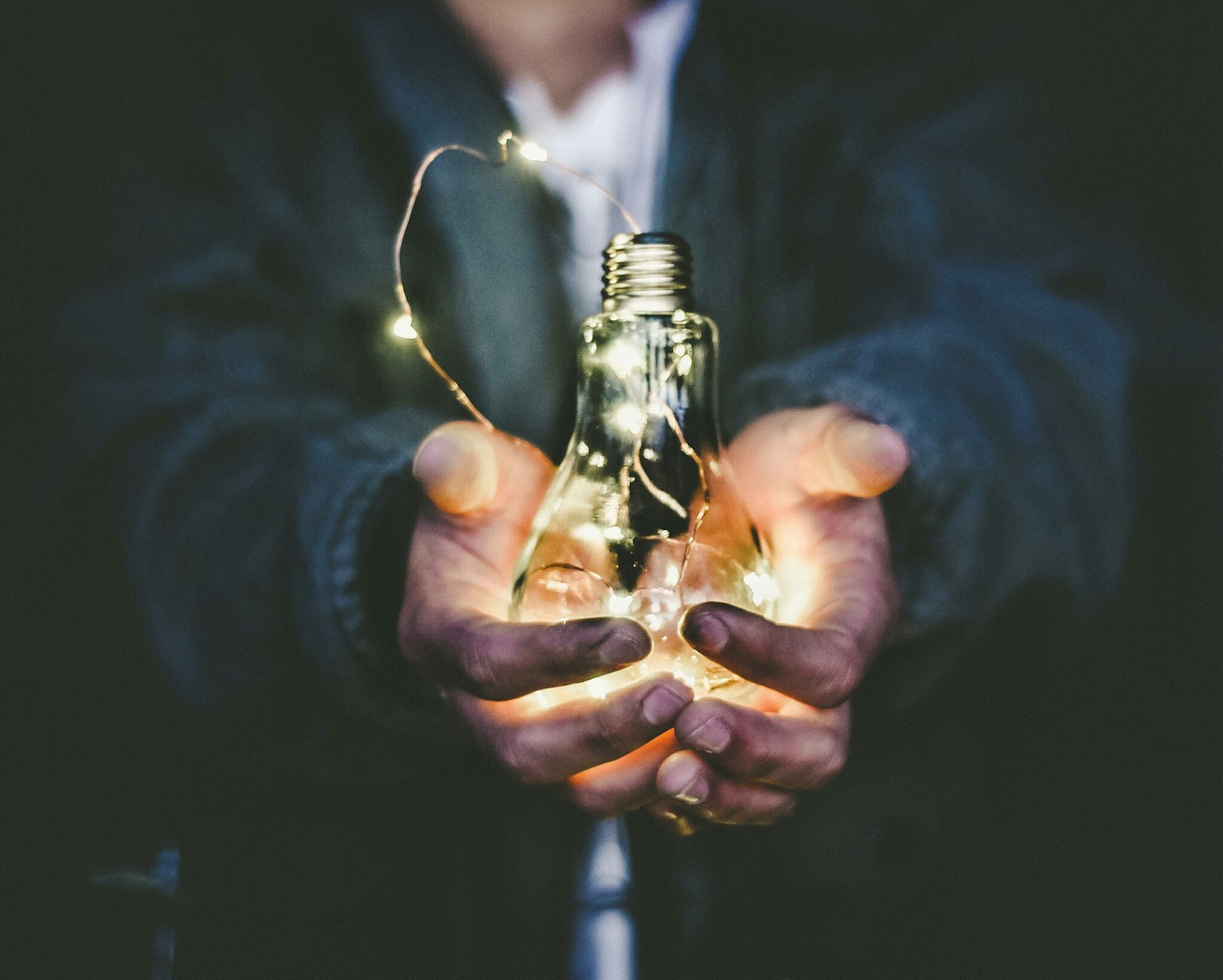 Image showing a man holding a light bulb